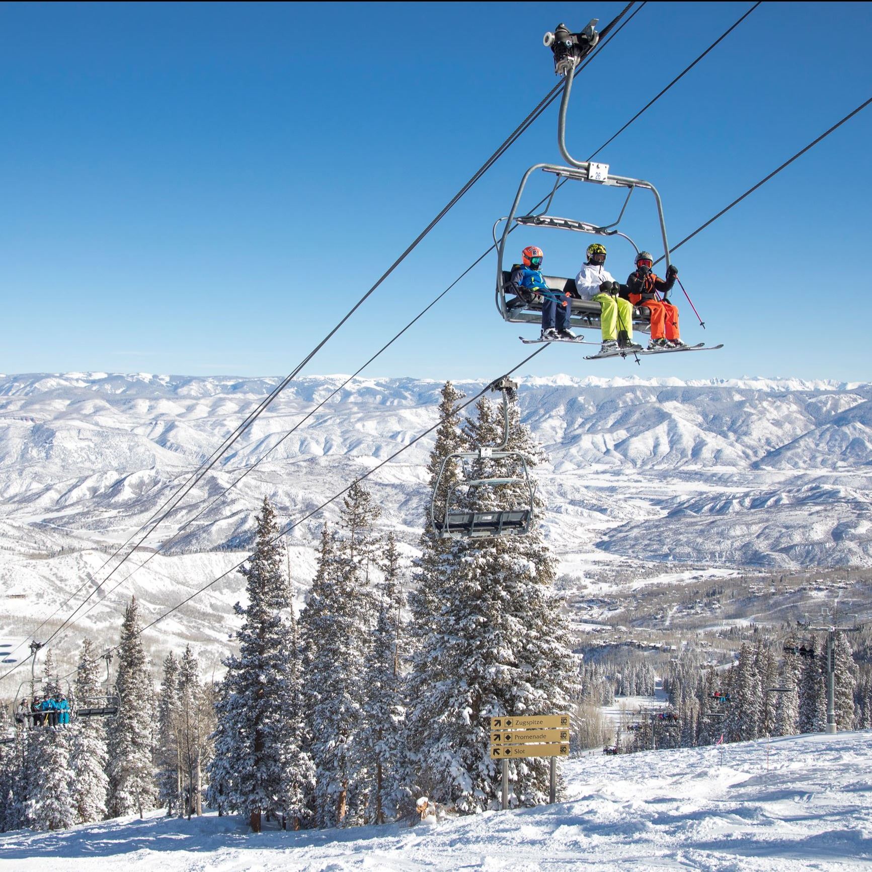 skiers riding ski lift